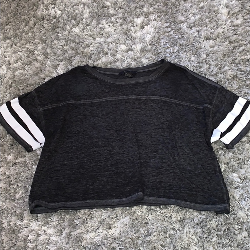 Charcoal gray t-shirt w/ white striped sleeves.